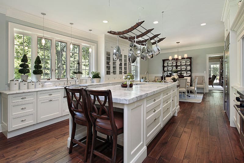 Kitchen In Luxury Home With White Bar Style Kitchen Island