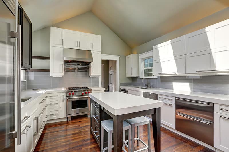 White Top Island In A Modern Style Kitchen With Vaulted Ceiling