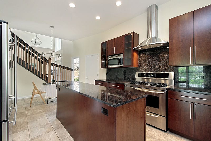 Powerful Yet Cozy Kitchen With Dark Colored Island And Cabinets