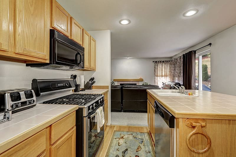 Skillful Arrangement Of Sink Kitchen Island And Other Furniture In A Newly Finished Apartment