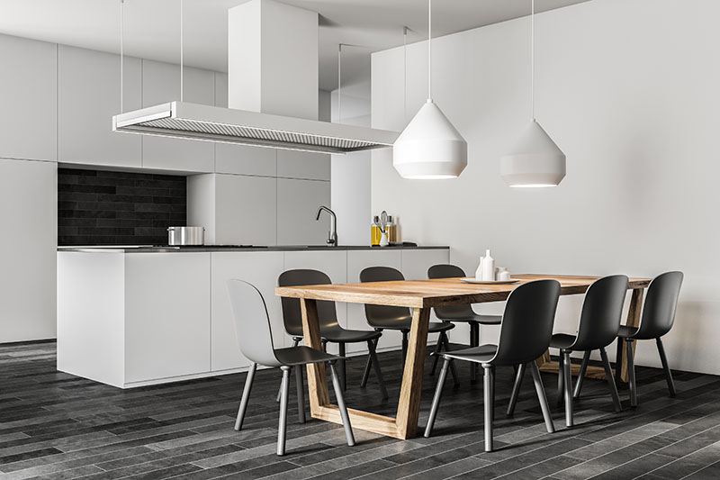 White Wall Kitchen Contrasts With Black Chair And Tile Flooring