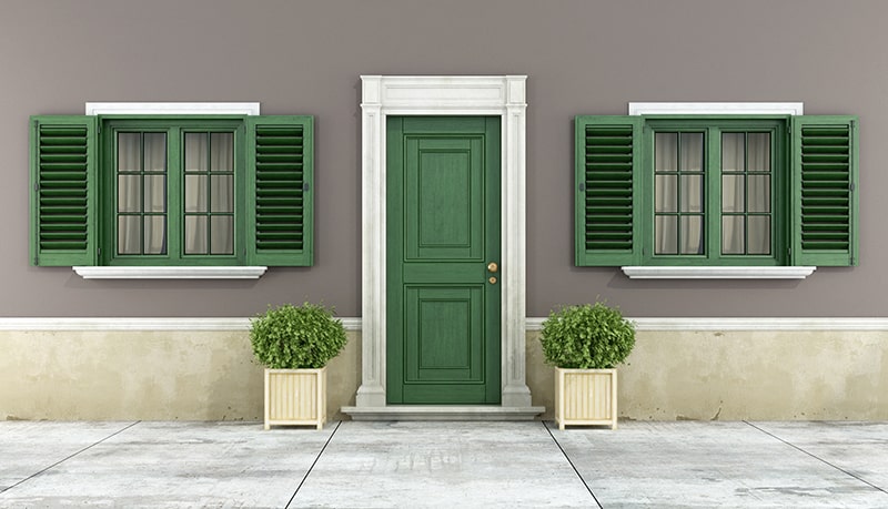 Classic Cottage with Green Door and Window Shutters