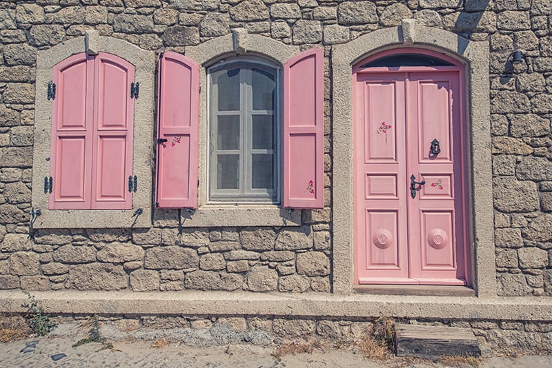 Vintage Pink Wooden Door on Stone