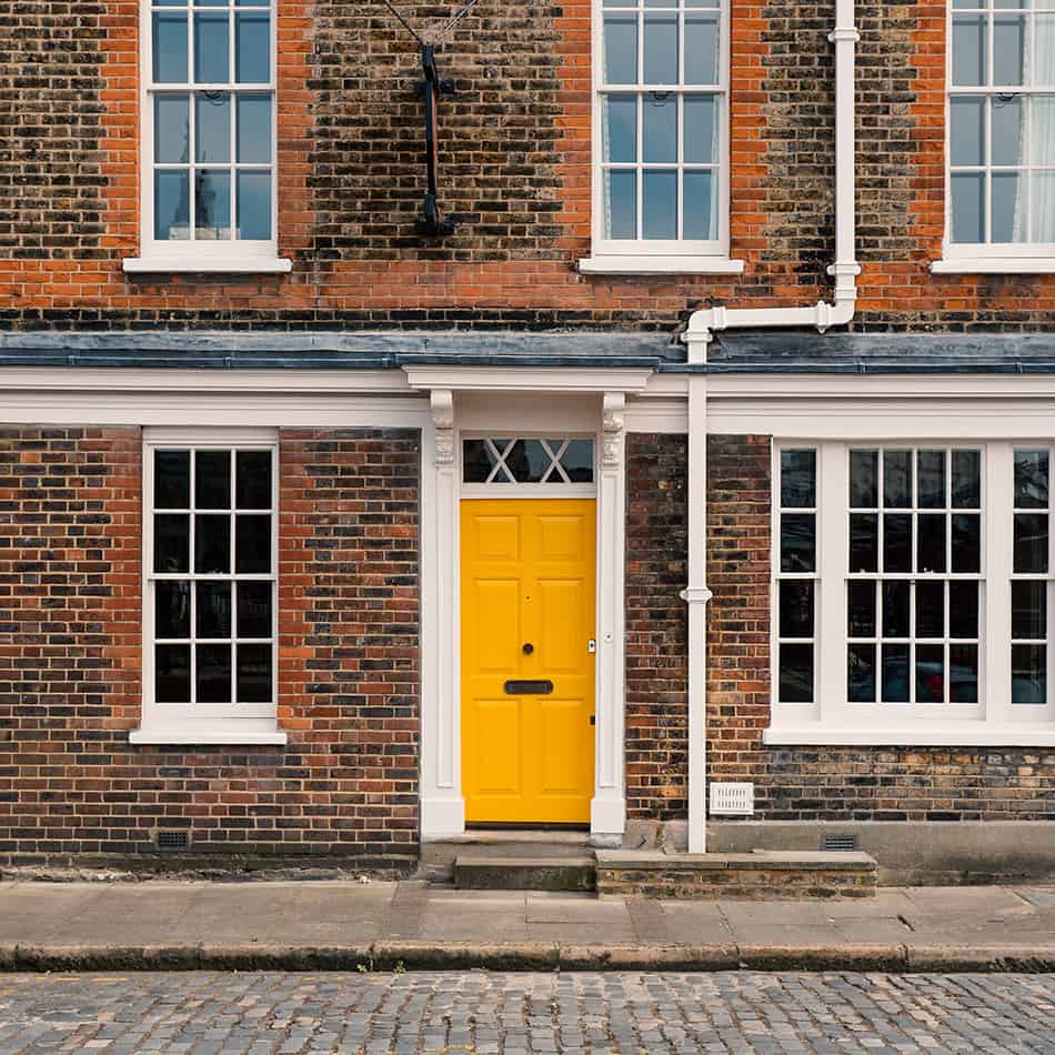 Yellow Door on a Brick House