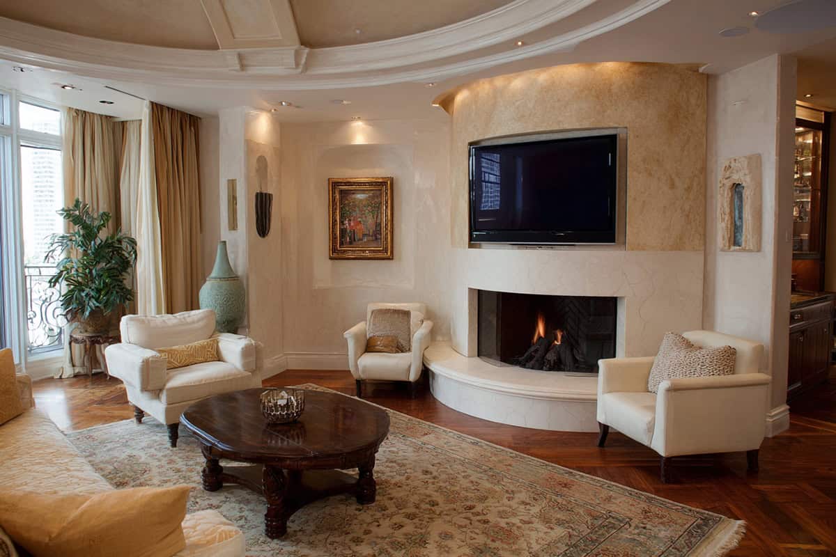 Traditional Curved Fireplace Paired with TV on a Plain Adjacent Wall