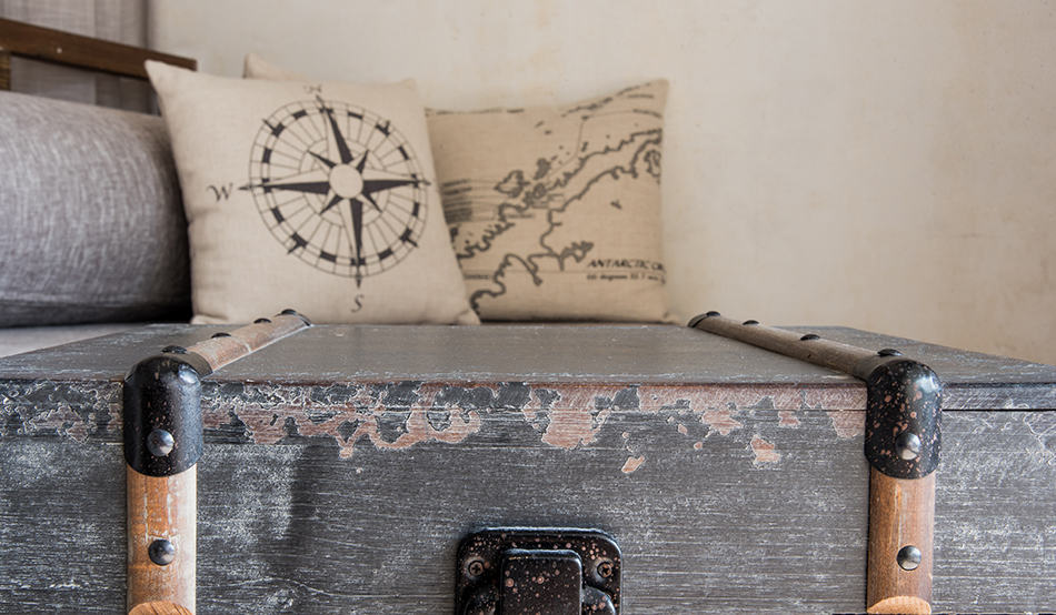 Map on wooden chest and cushions 