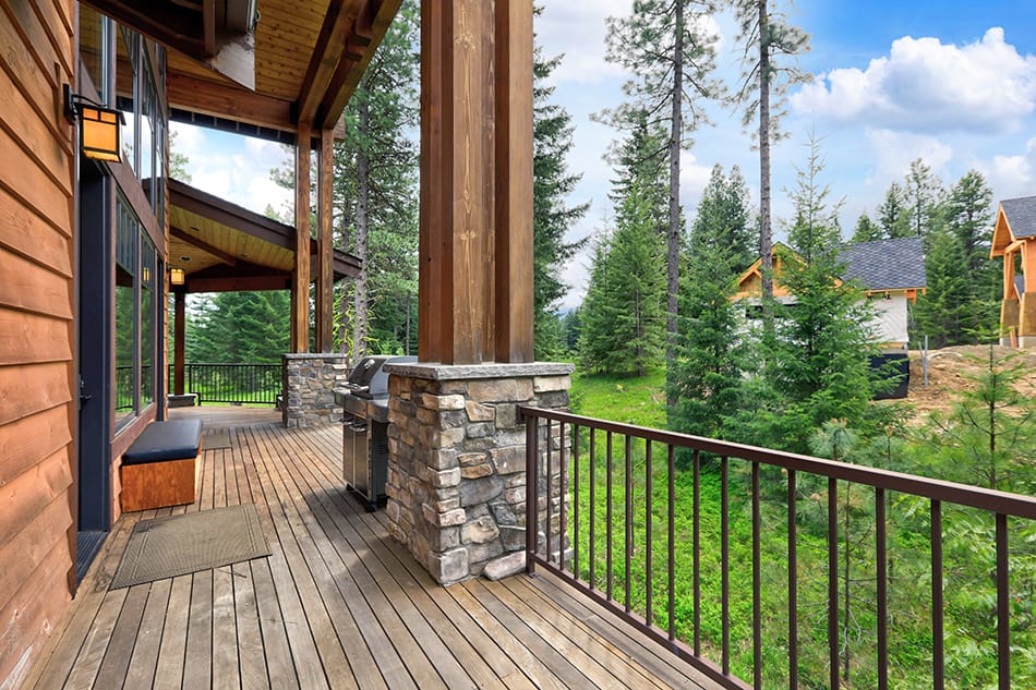 Traditional Home with Stone Columns and Vertical Aluminum Railings