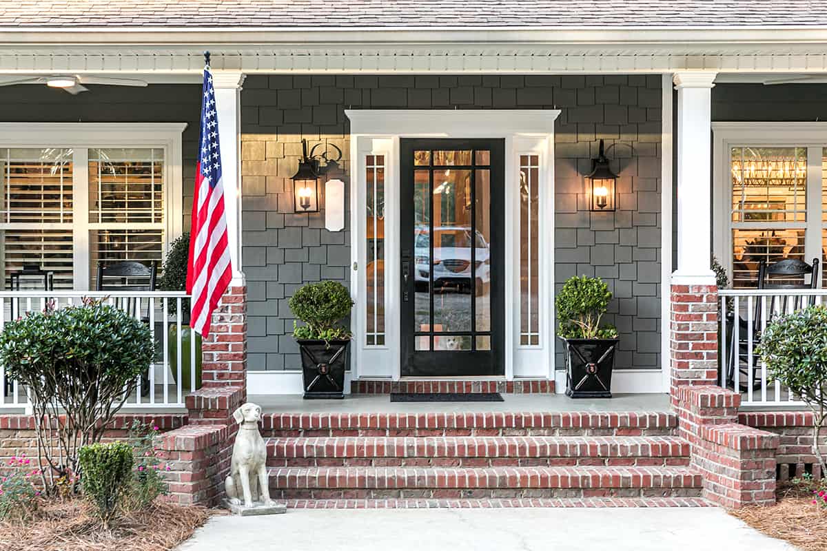 Black Front Door, Gray Siding and Red Brick Steps