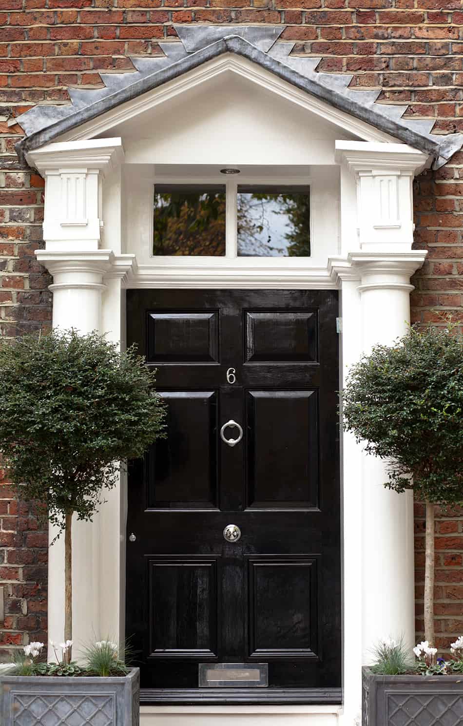 Black Door on Traditional Brown Brick House