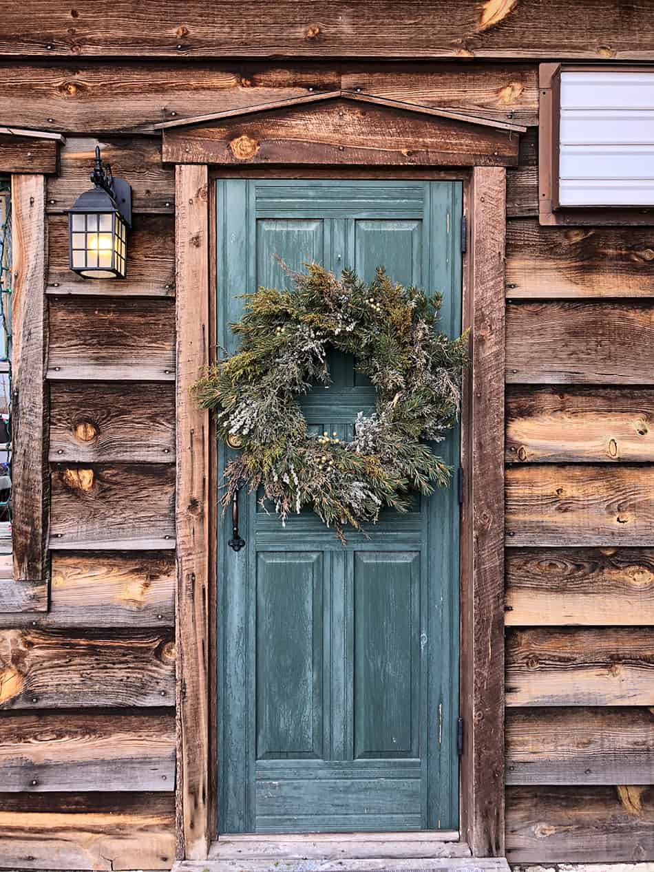 Blue Door on Rustic Brown Wooden Siding