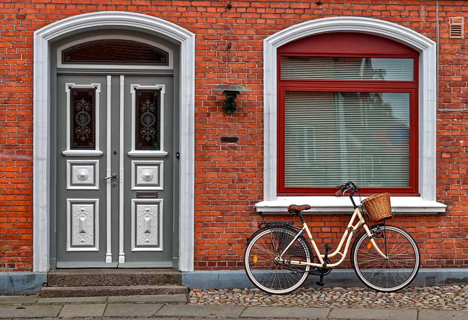 White and Gray Front Door and Red Brick House