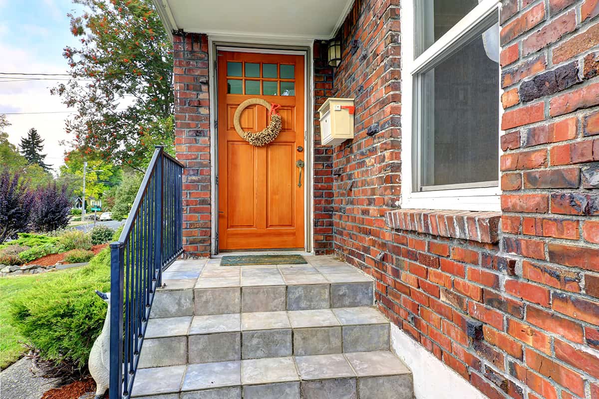 Orange Front Door and Red Brick House