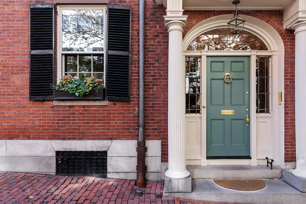 Teal Front Door and Red Brick House