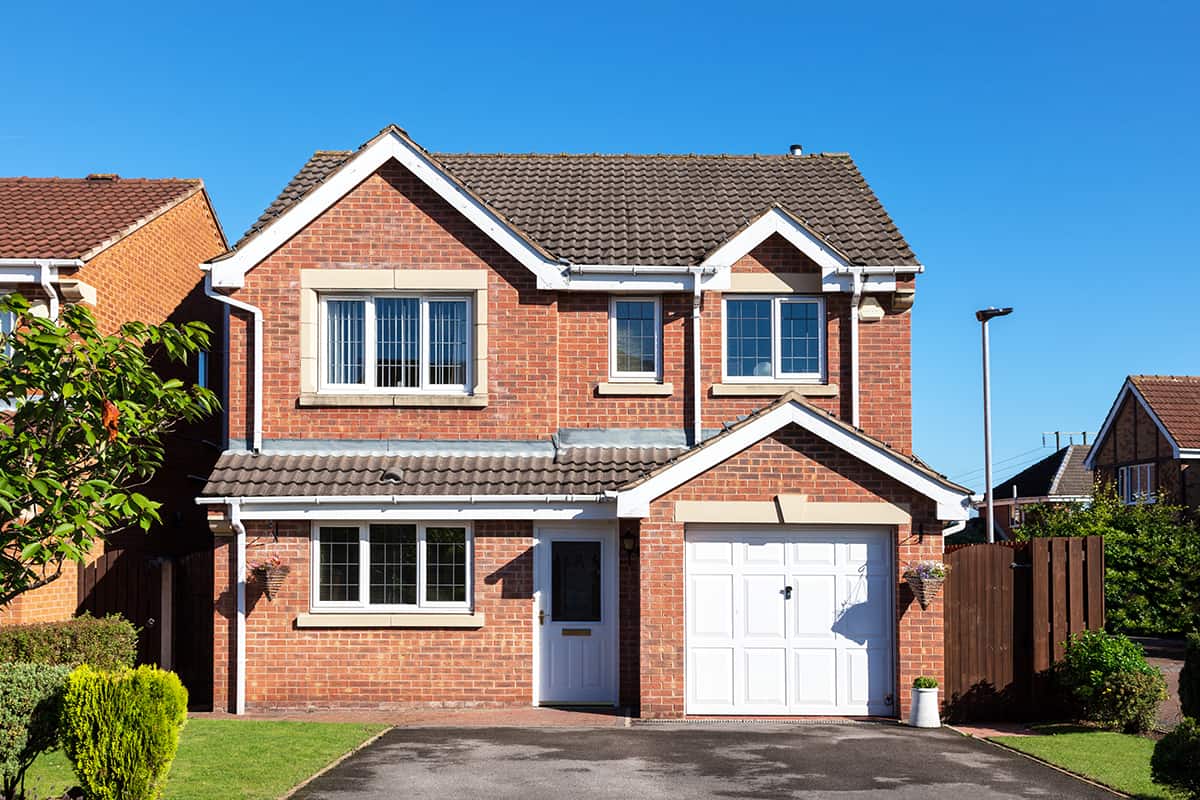 White front door and red brick house