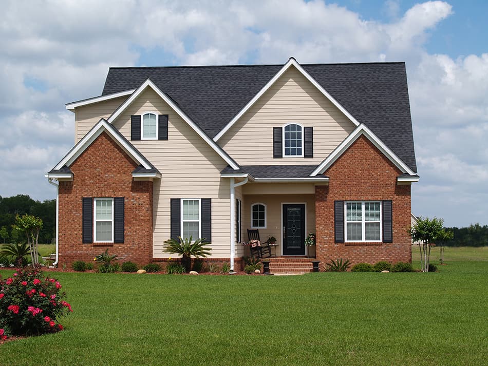 Beige house with a black roof