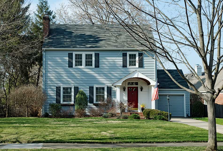 Light blue house with a black roof