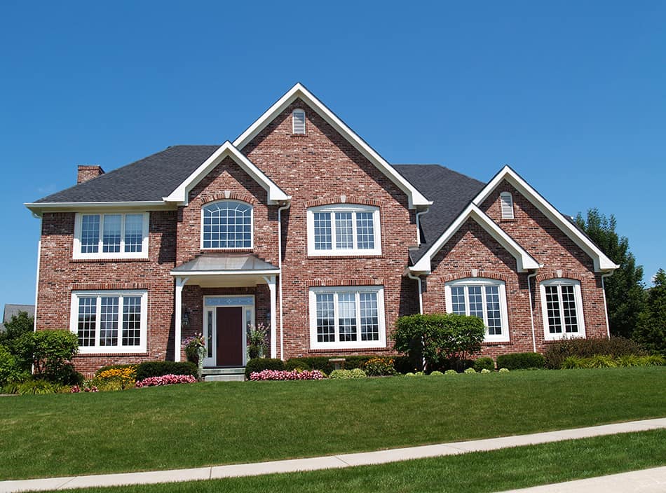 Red brick house with a black roof