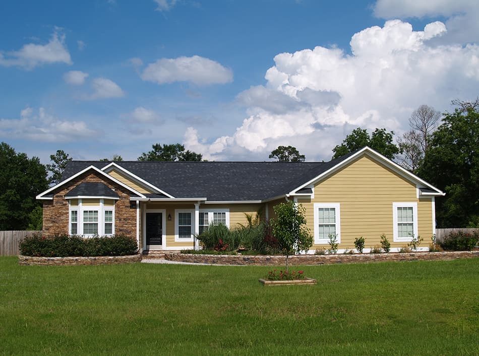 Yellow house with a black roof