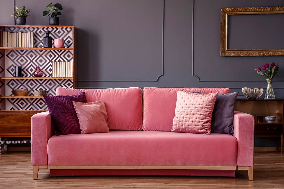 Pink couch and grey walls