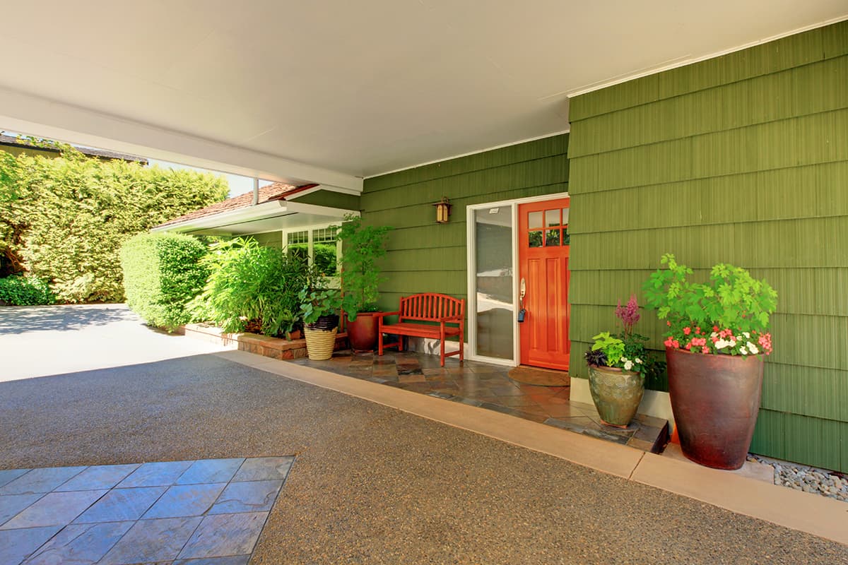 Brown Front Door for a Green House with Brown Trim