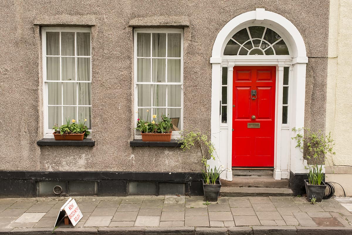 Light Red Door with White Trim on Gray Exterior