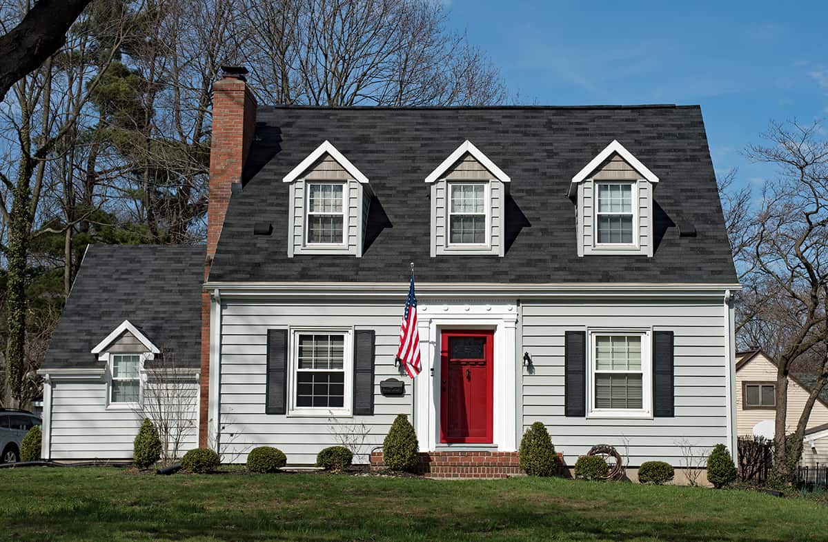 Red Door with Black Shutters on Gray Exterior