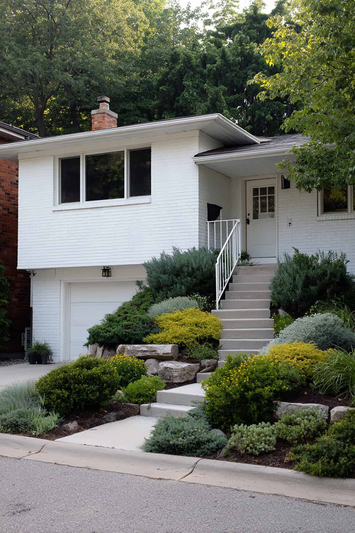 Clean White Brick Split Level With Simple Landscaping