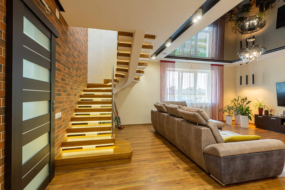 Modern Living Room with Lit Staircase