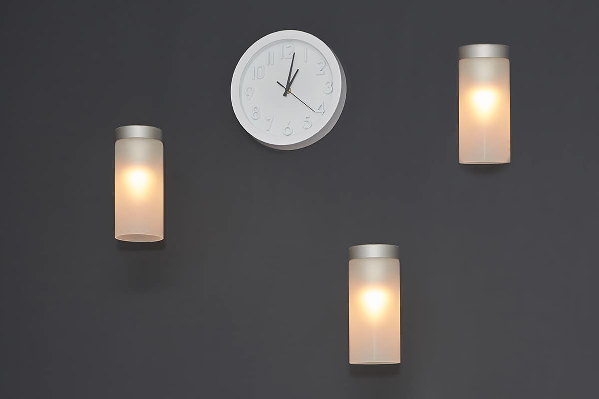 Illuminate the Clock with Wall Sconces