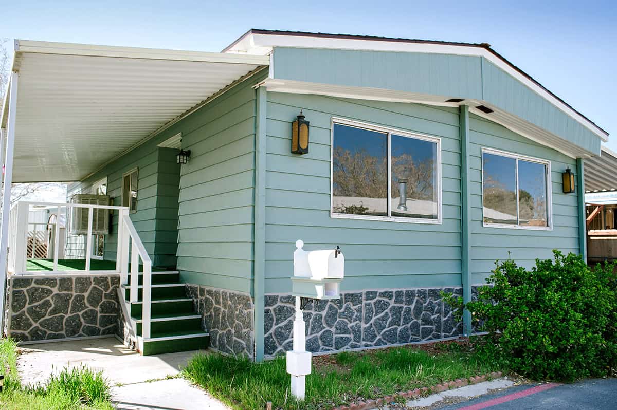 Soft Green Siding with Stone Trim on a Ranch Style Home