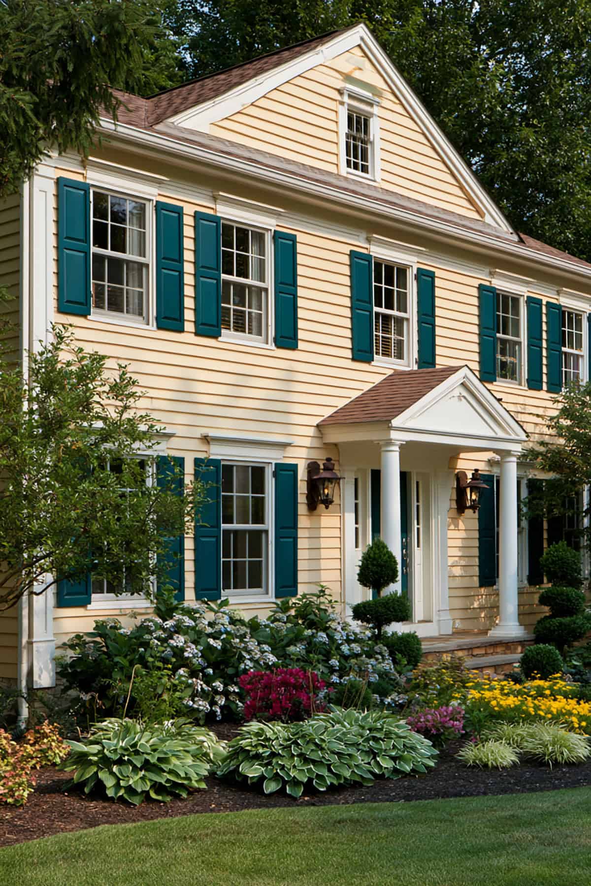 Deep Teal Shutters With Cream Siding