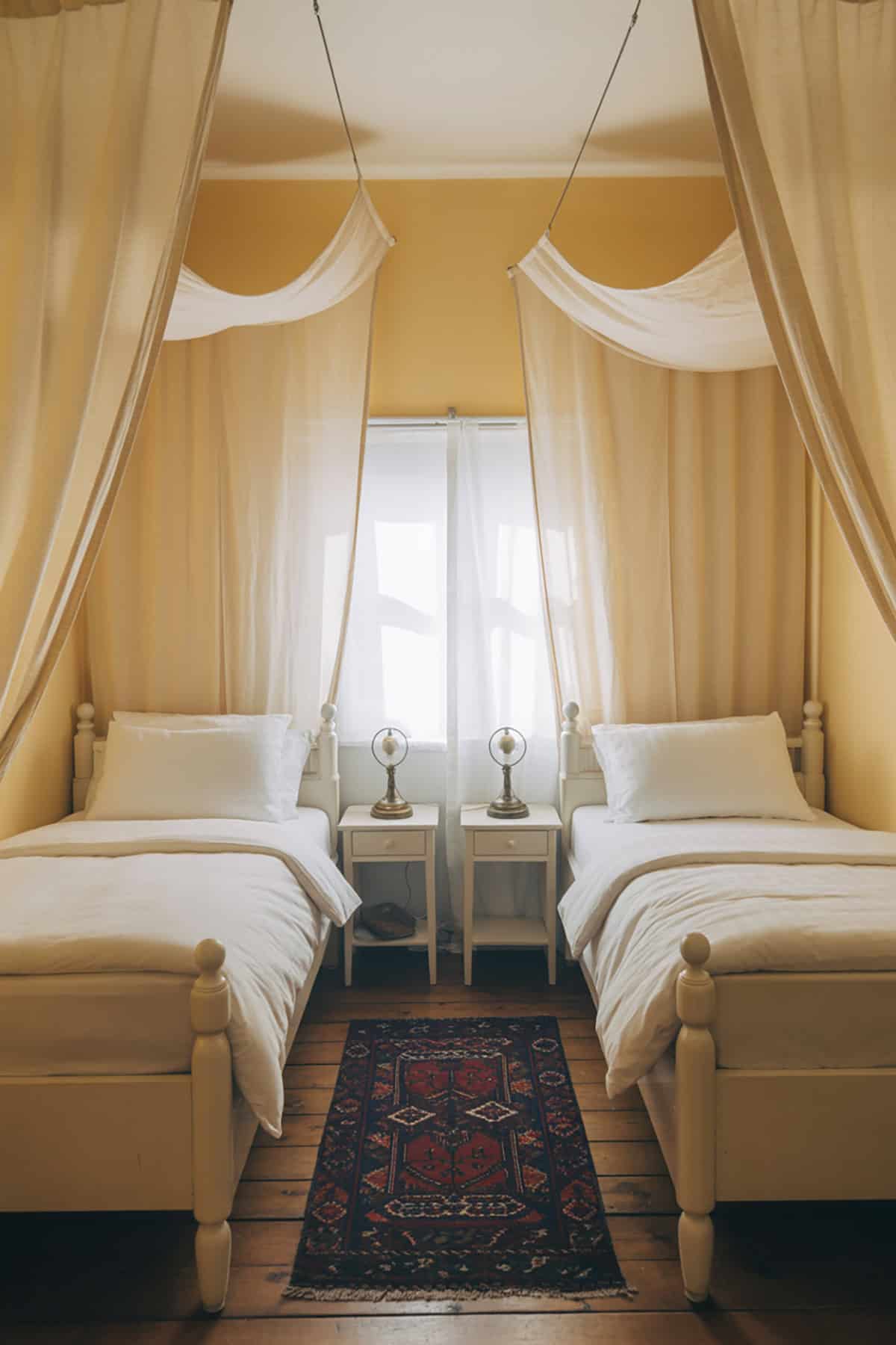 Beds Separated by a Curtain Divider
