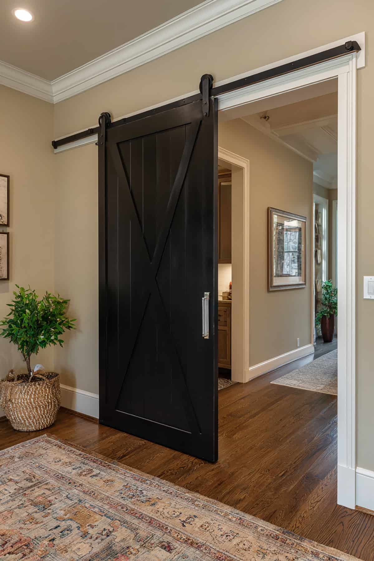 Black Barn Door with Traditional White Trim Frame