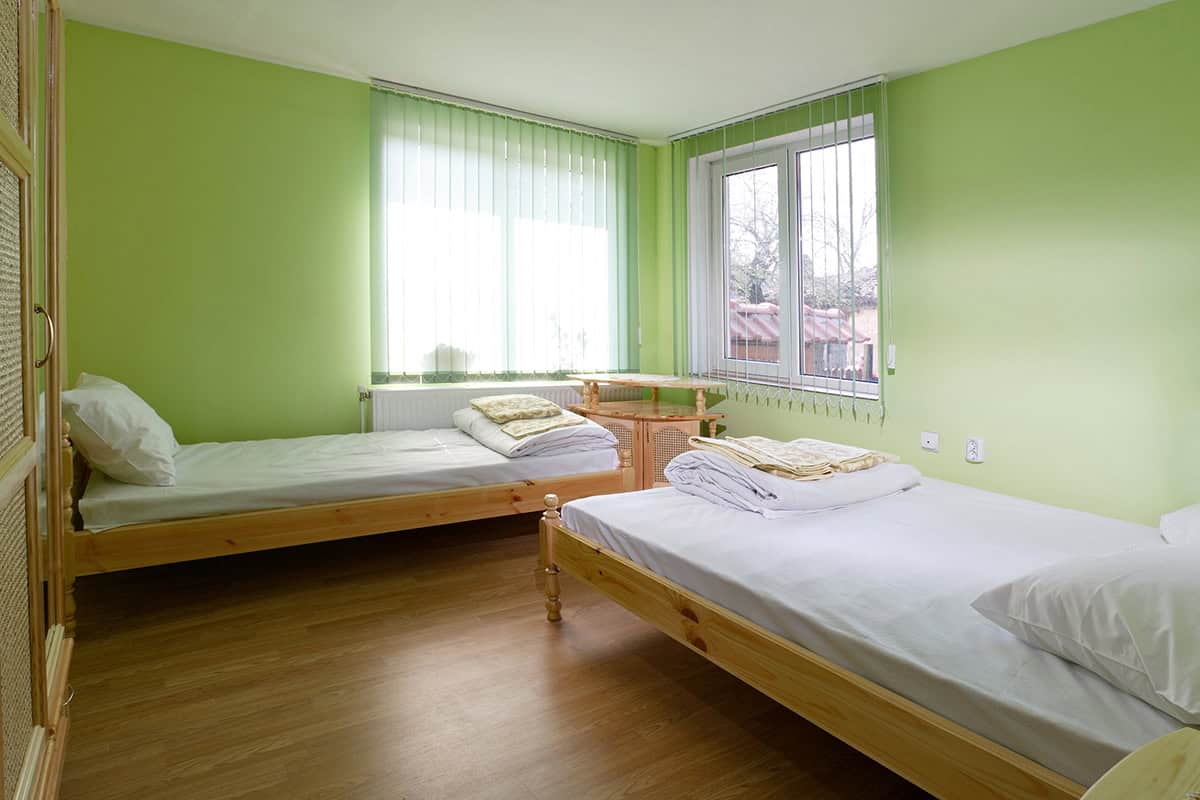 Bright and Airy with Two Natural Wood Beds