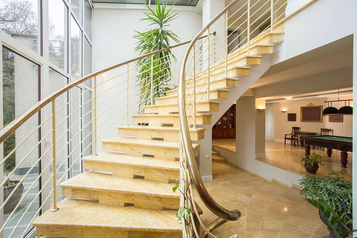 Curved Marble Stair Landing with Gold Details