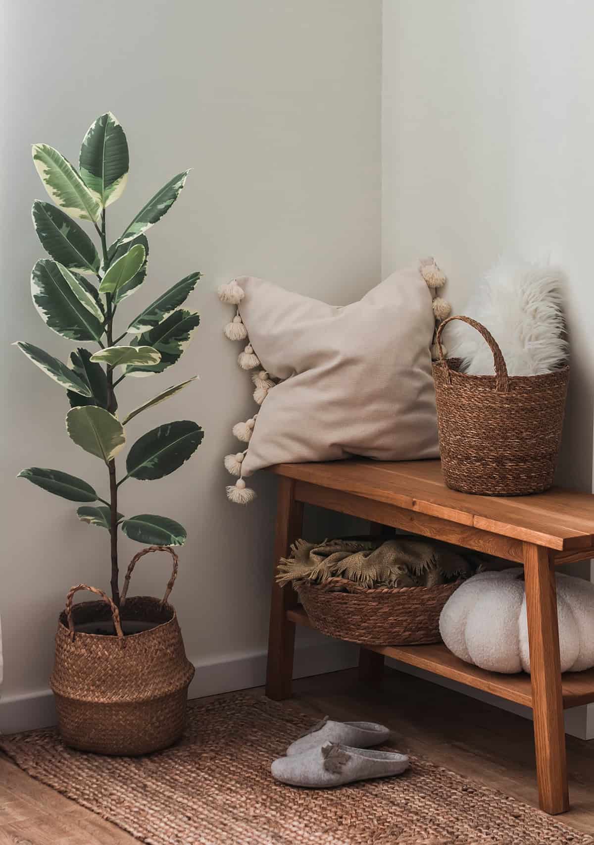 A Cozy Corner with Wooden Bench, Pillows, and Baskets