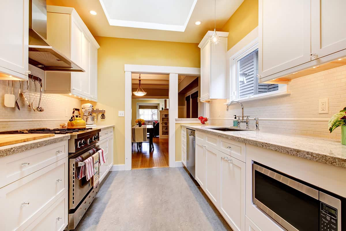 Bright Galley Kitchen With Yellow Accents