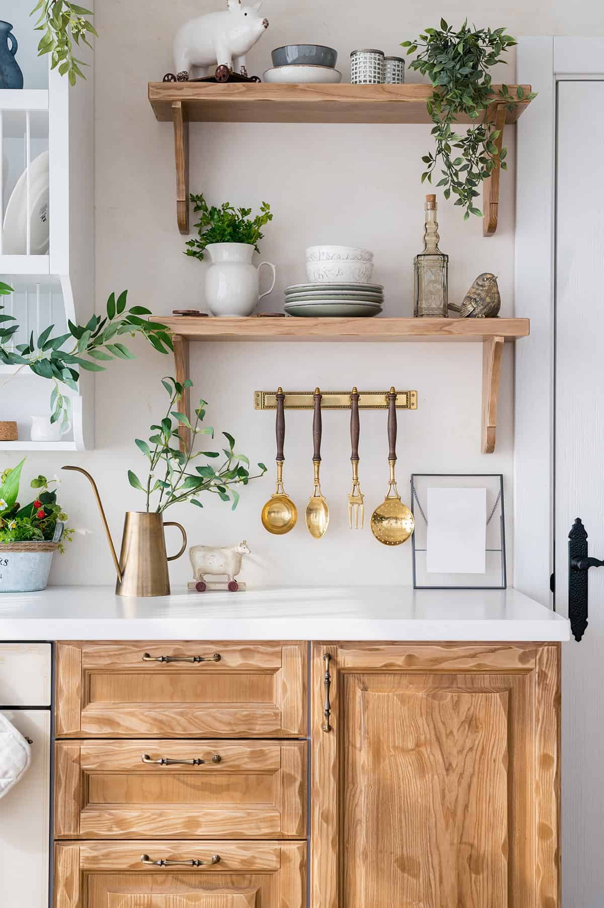 Scandinavian Counter With Open Shelves and Brass Accents