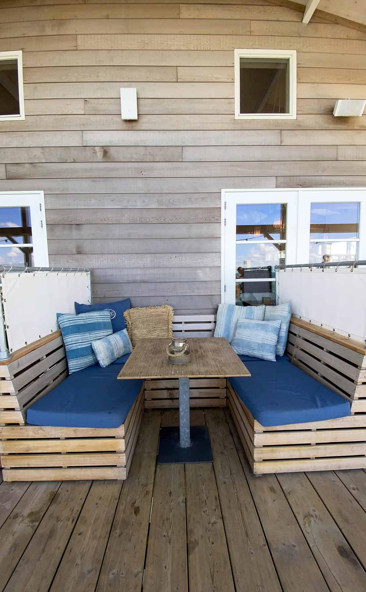 Beach House Patio with Weathered Wood and Blue Cushions