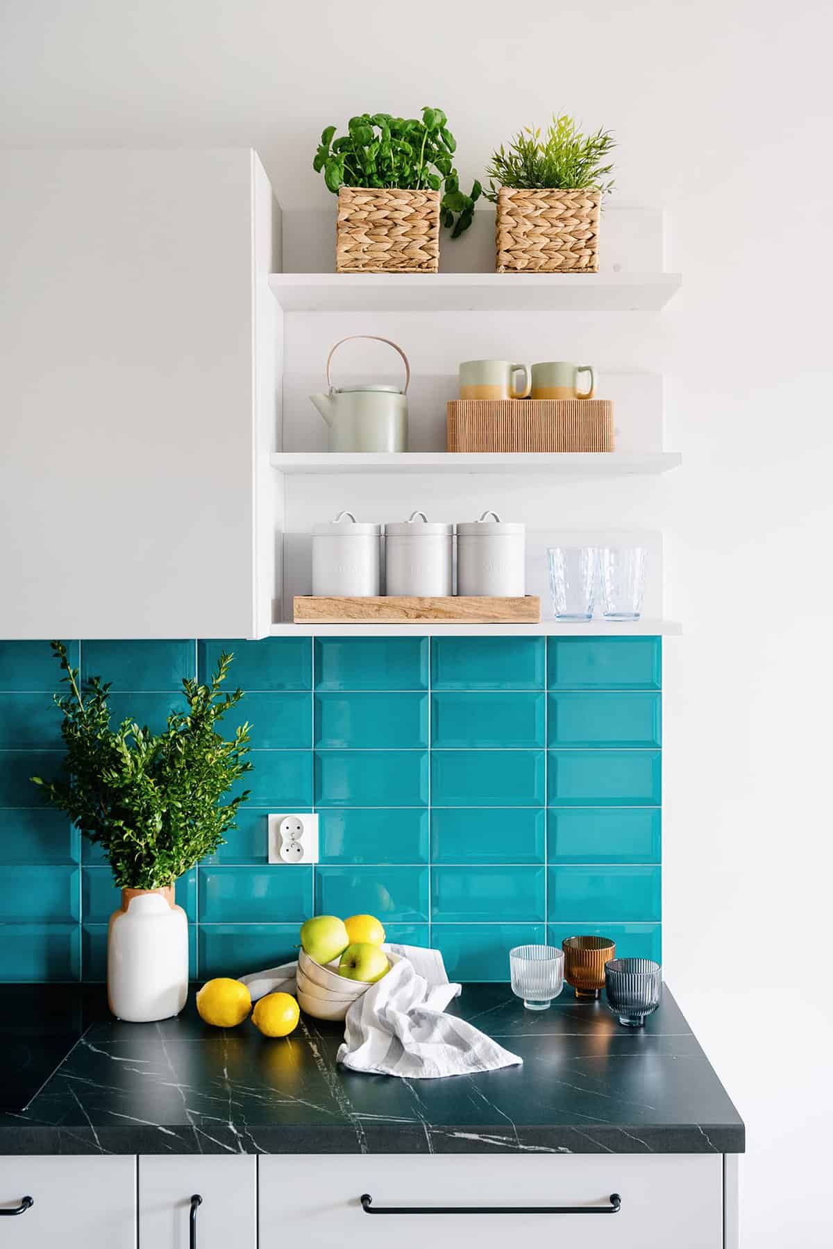 Blue Kitchen with White Cabinets and Deep Marble Countertops