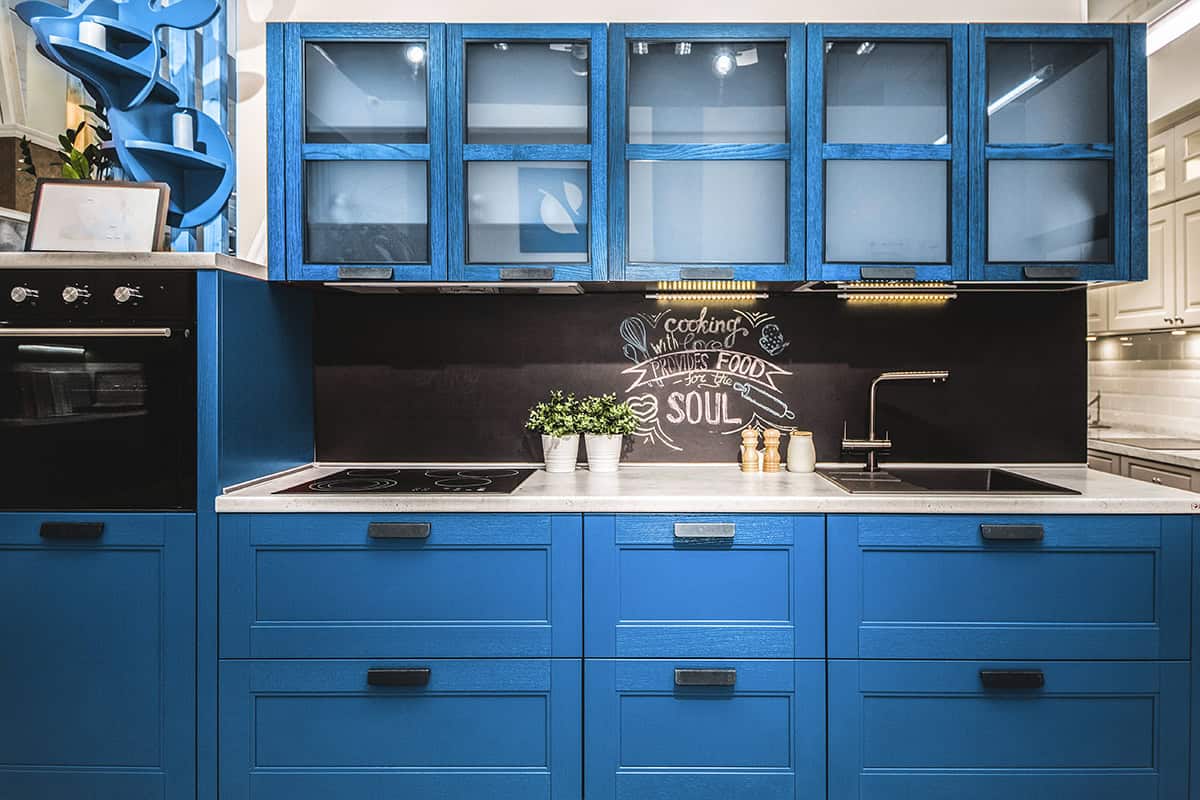Bold Blue Kitchen with Black Brick Wall and Wooden Counters