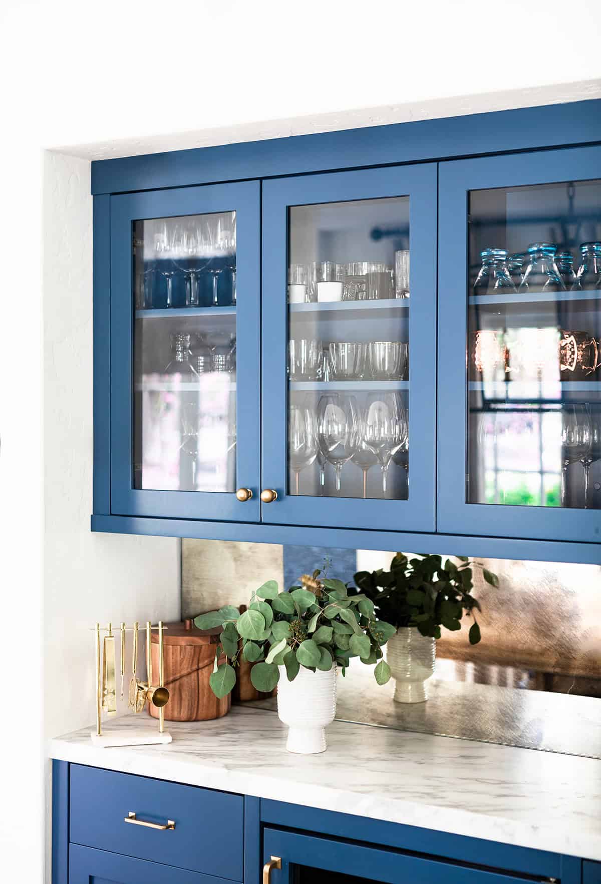 Clean Blue Cabinet Display with Brass Hardware and Glass Doors