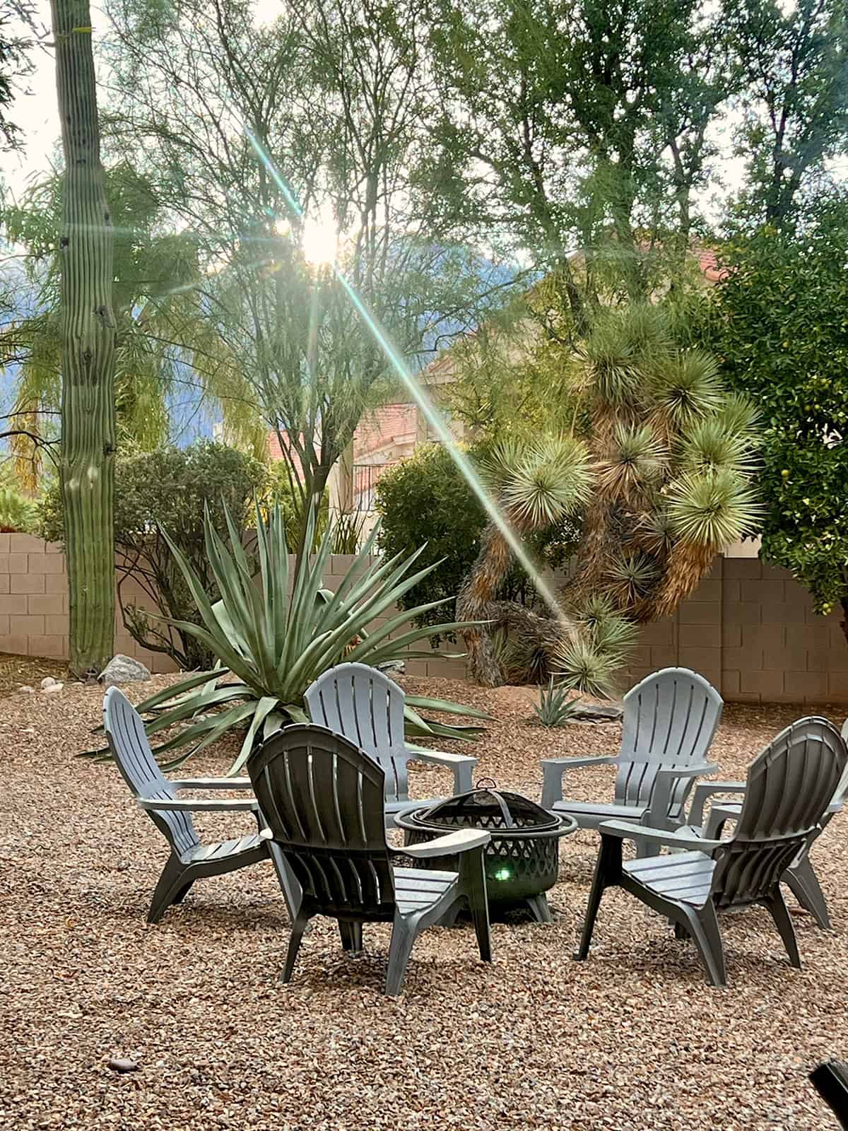 Desert Patio with Adirondack Chairs Around Fire Pit