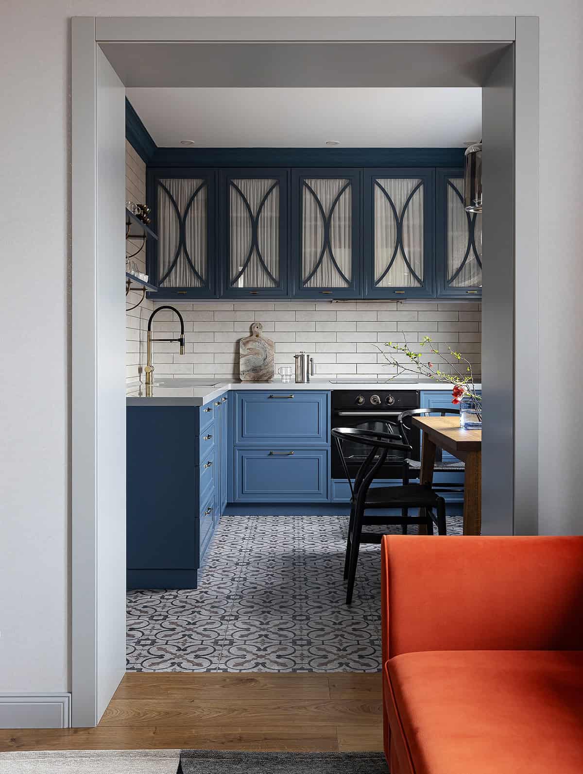 Elegant Blue Kitchen with Patterned Floors and Framed Cabinetry