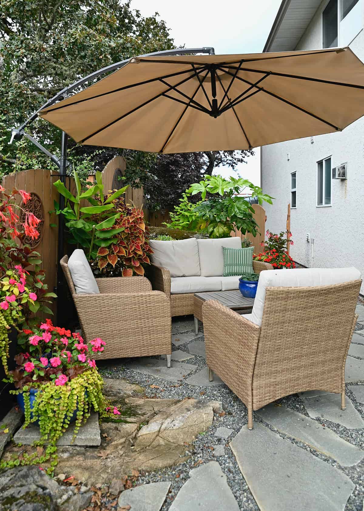 Mediterranean Backyard Patio with Light Wood Furniture