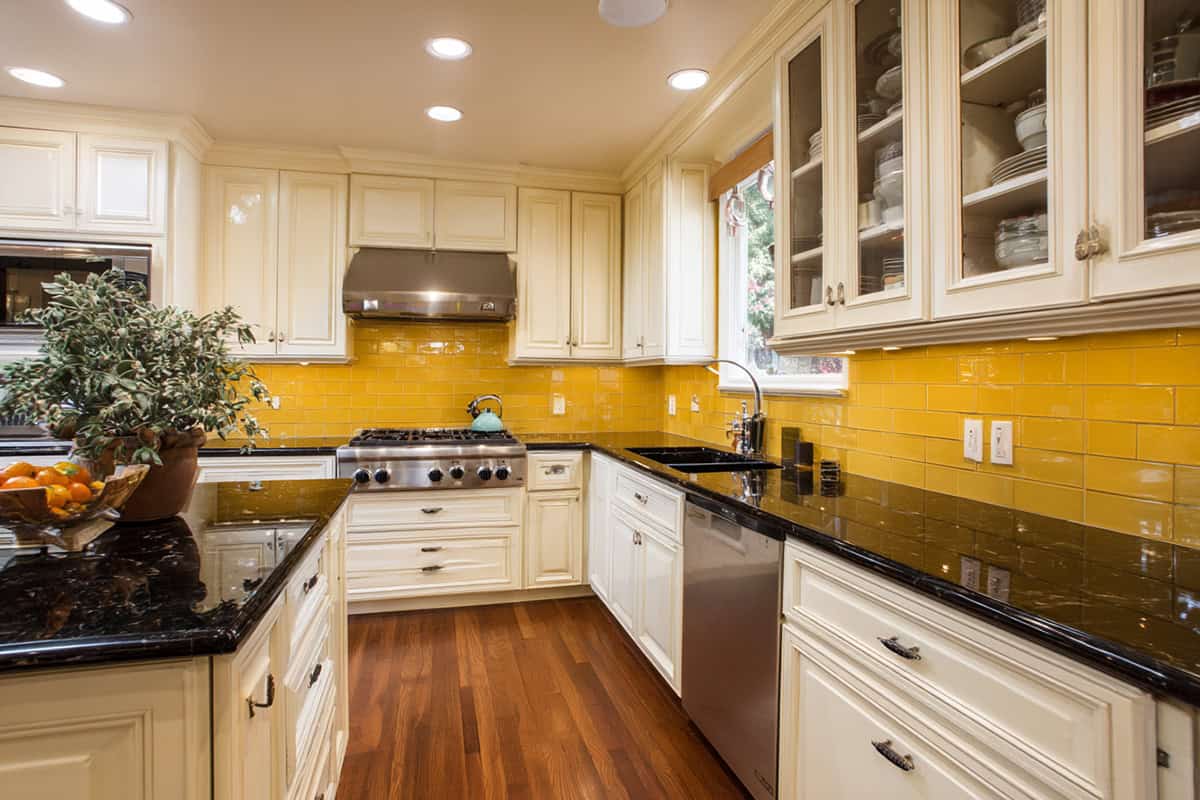 Soft Mustard Yellow Backsplash with Cream Cabinets