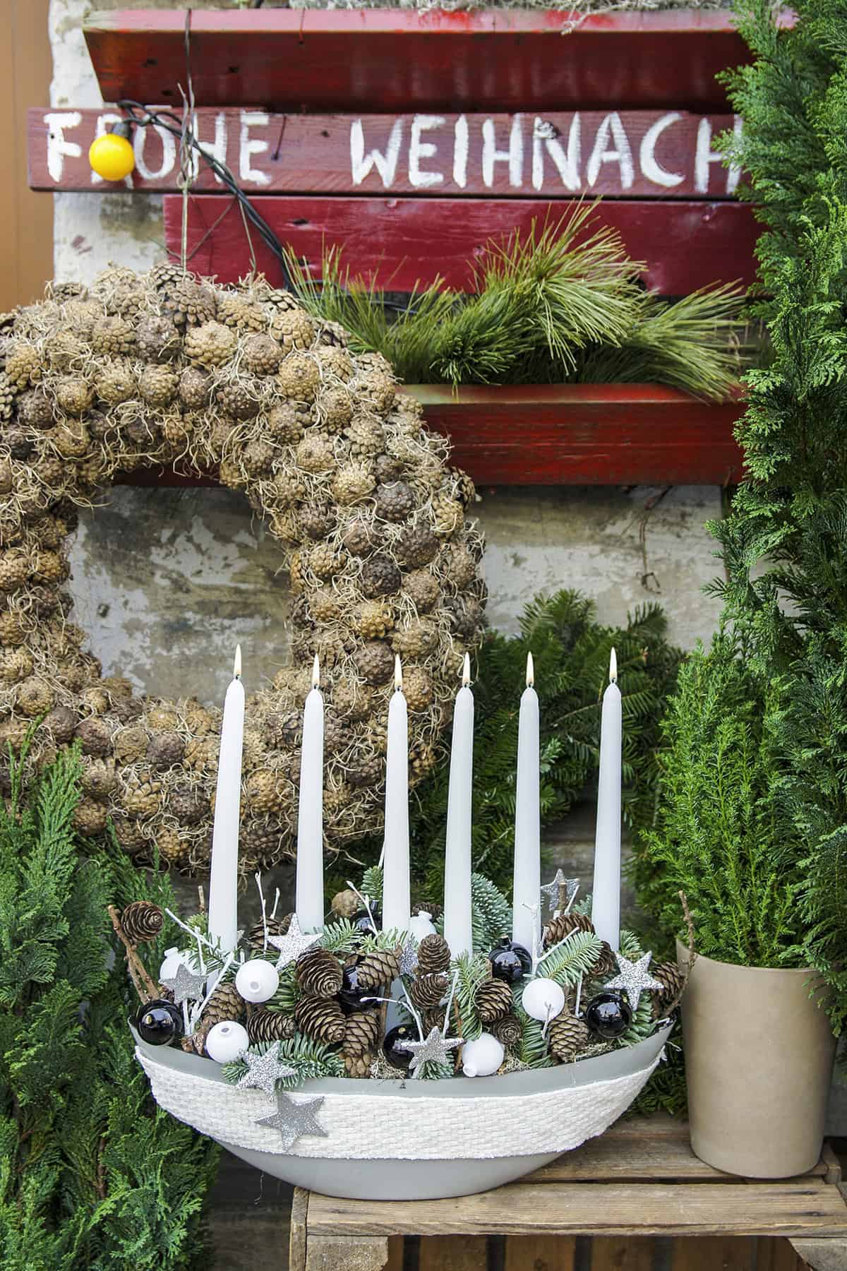 White Candle Display with Pinecones and Ornaments