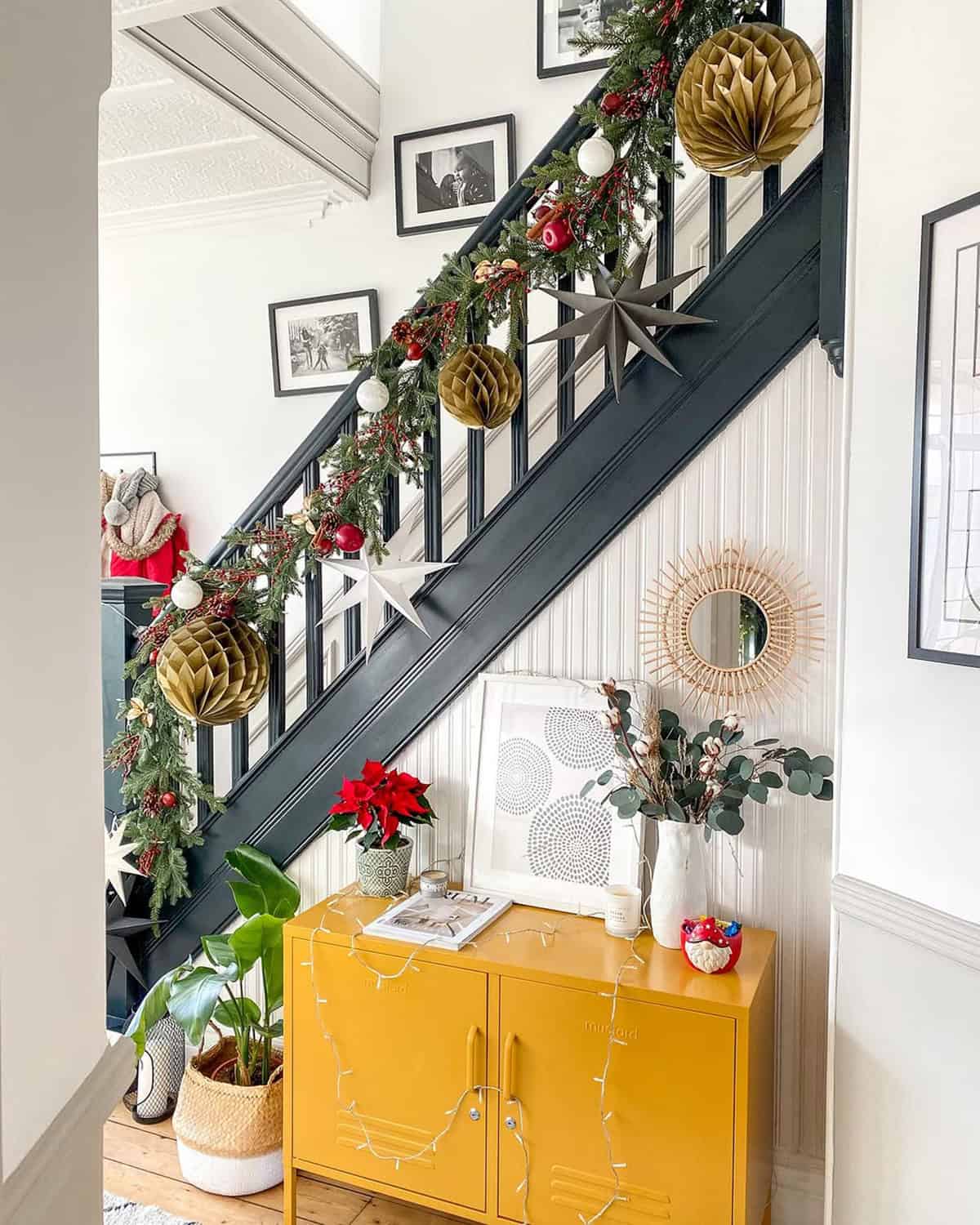 Black Rail Staircase with Paper Ornaments and Green Garland