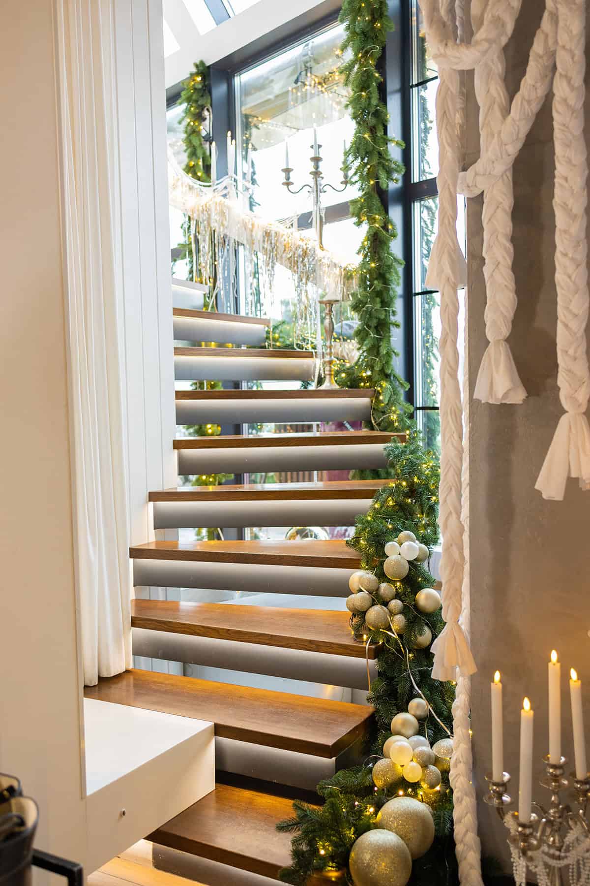 Glass Rail Staircase with Gold and Green Accents