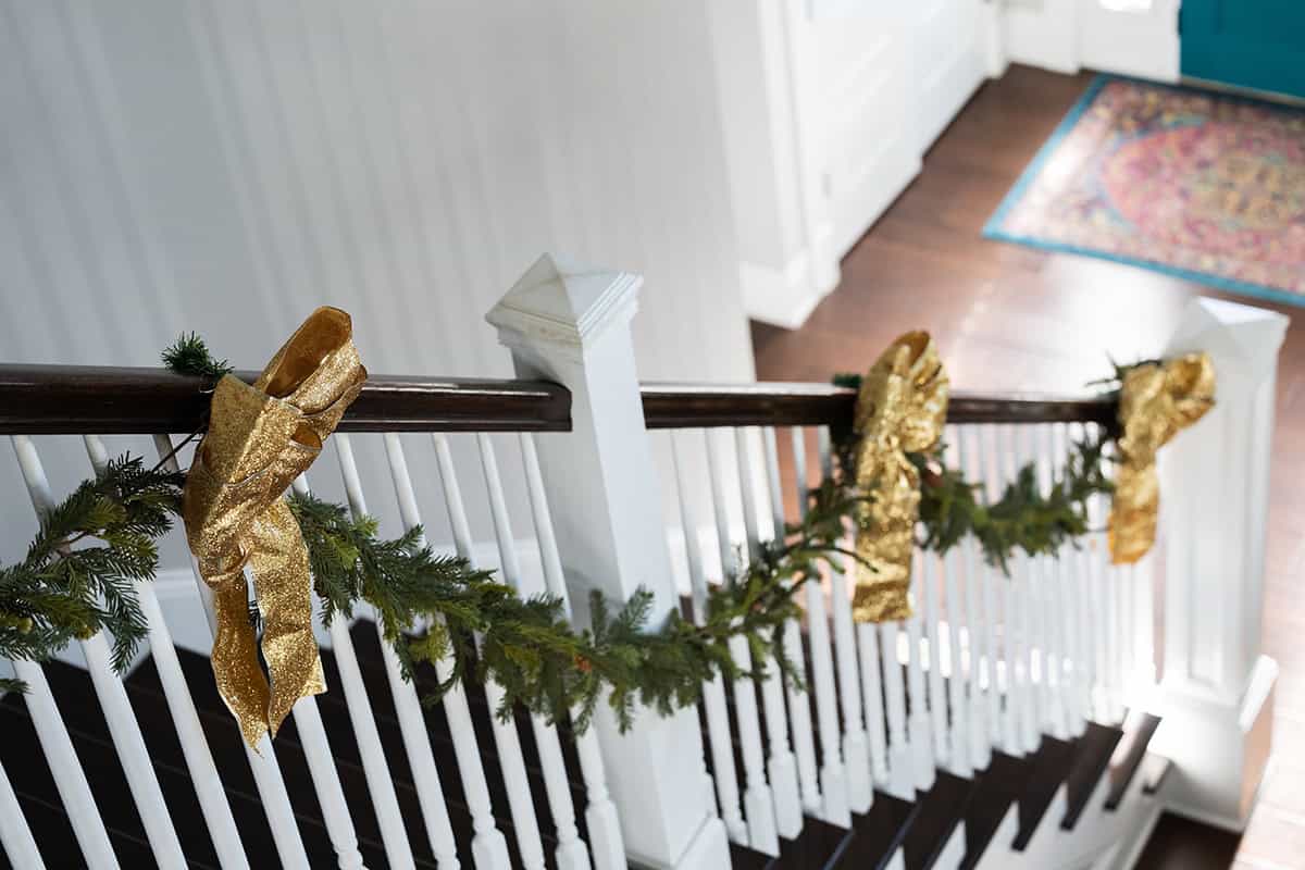 Green Garland and Gold Bow Staircase